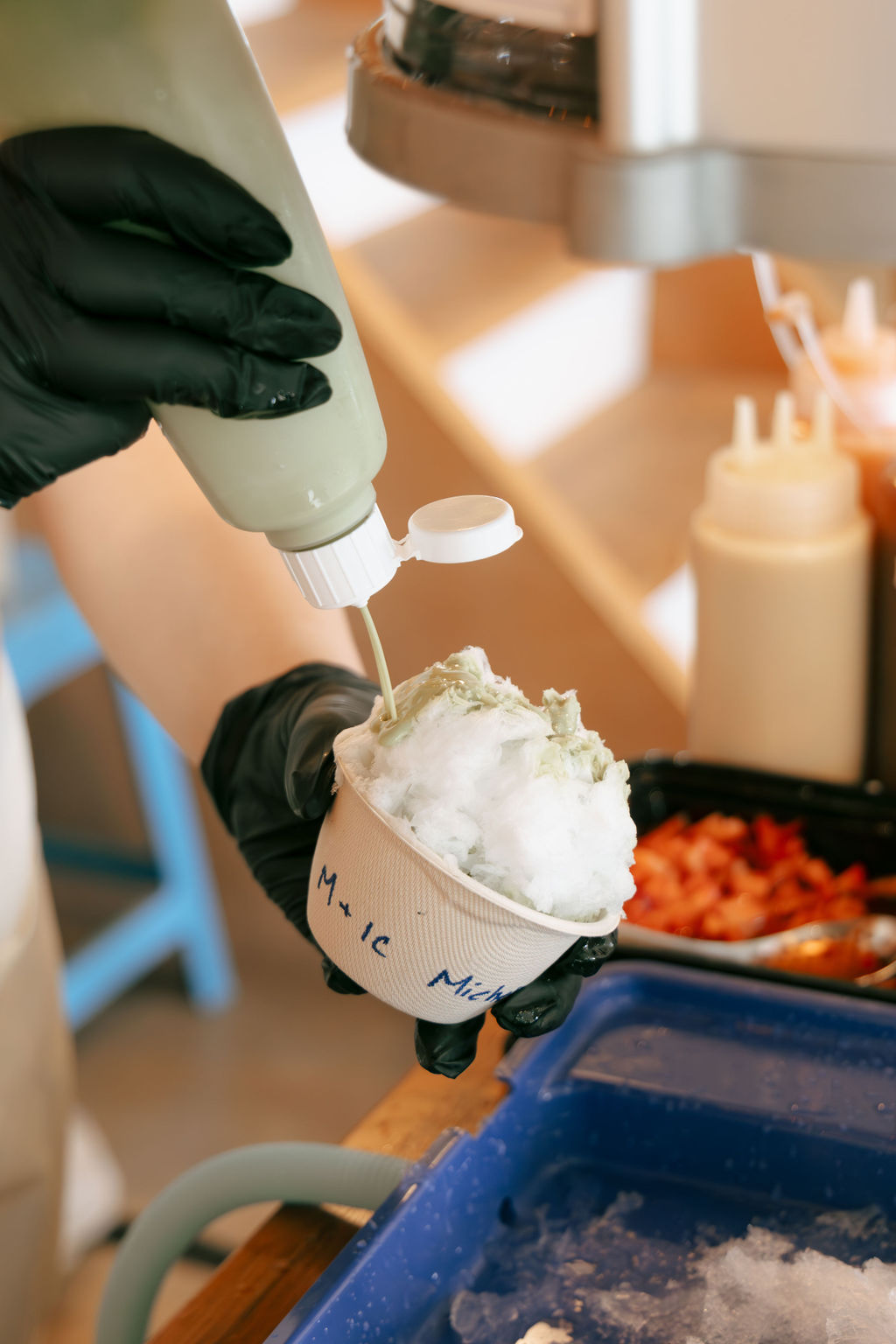 Pouring syrup on shaved ice